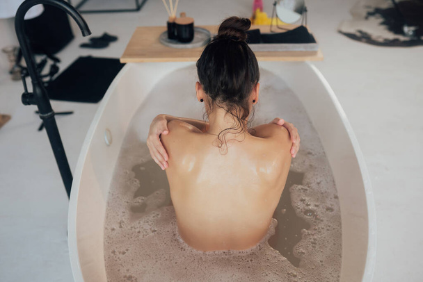 Pretty young woman taking bath at home - Foto, imagen
