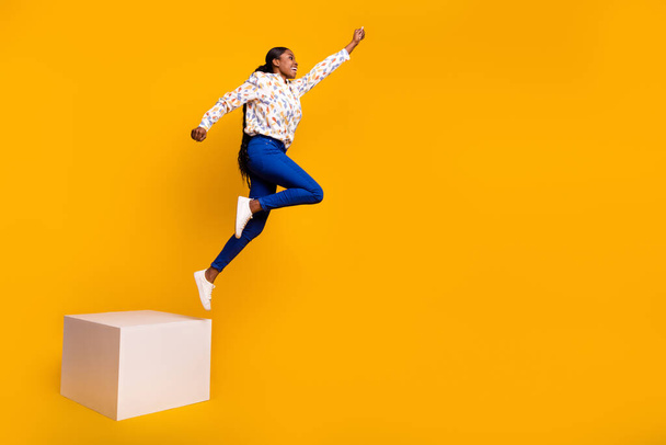 Full length body size view of attractive cheerful girl jumping training isolated over bright yellow color background. - Fotoğraf, Görsel