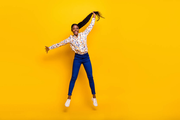 Full length body size view of attractive cheerful girly girl jumping holding tail isolated over bright yellow color background. - Φωτογραφία, εικόνα