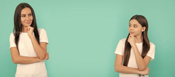 Mother and daughter child banner, copy space, isolated background. Thoughtful mother and daughter with pensive look keep hands on chin blue background, imagination - Photo, Image