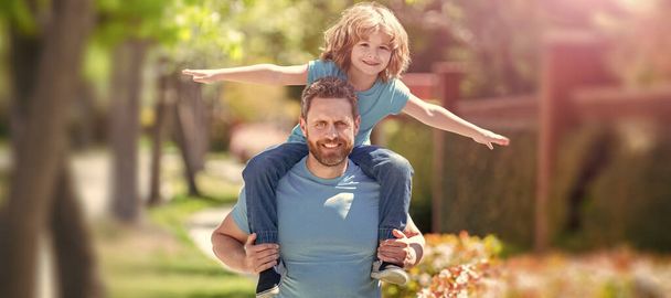 Banner of father and son walk, cheerful father and son have fun in park. family value. childhood and parenthood - Фото, изображение
