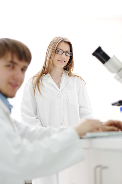 Science team working with microscopes in a laboratory - Fotoğraf, Görsel
