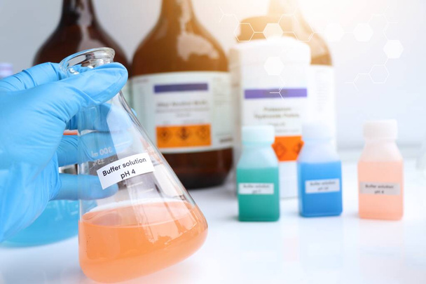 Buffer solution in glass, chemical in the laboratory and industry, Chemicals used in the analysis - Photo, Image