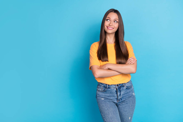 Photo of cute positive lady bright shiny toothy grin interested look empty space low price trendy clothes isolated on blue color background. - 写真・画像