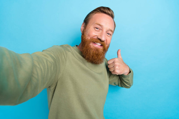 Photo of handsome cheerful guy with ginger hairstyle khaki long sleeve showing like thumb up good job isolated on teal color background. - Fotografie, Obrázek