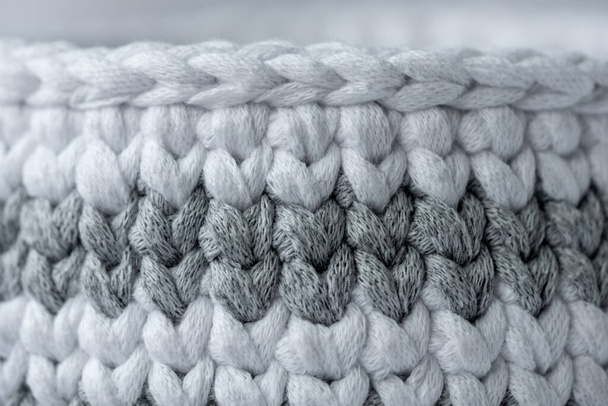 gray and white striped hand crocheted storage basket. Cozy interior item on a white background. Sustainable handicraft business - Valokuva, kuva