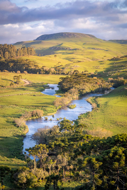 Southern Brazil, Sao Jose dos Ausentes countryside and river landscape at peaceful golden sunset, long exposure - 写真・画像