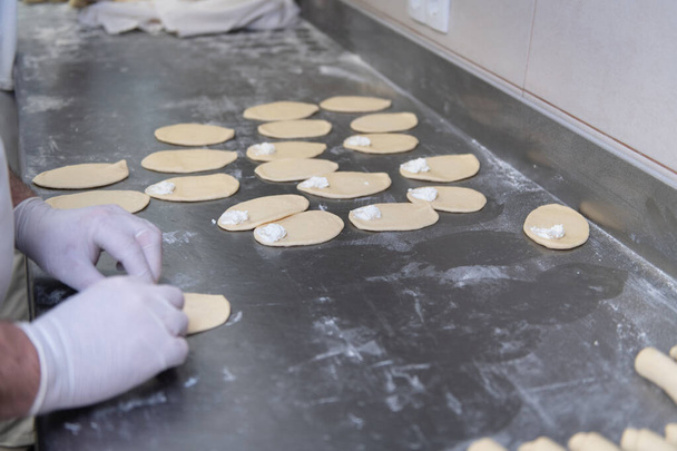 Young Pastry Chef Making Some Dessert with Cheese in the Bakery Cooking Process Before Going to the Oven - 写真・画像
