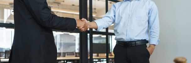Concept of lawyer counseling, Businessman and senior lawyer shake hands after negotiating deal. - 写真・画像