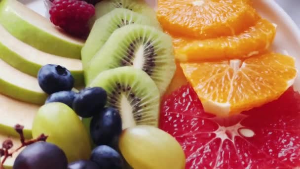 Talerz owoców na serwowanym stole dla gościnności i gastronomii. Wysokiej jakości materiał 4k - Materiał filmowy, wideo