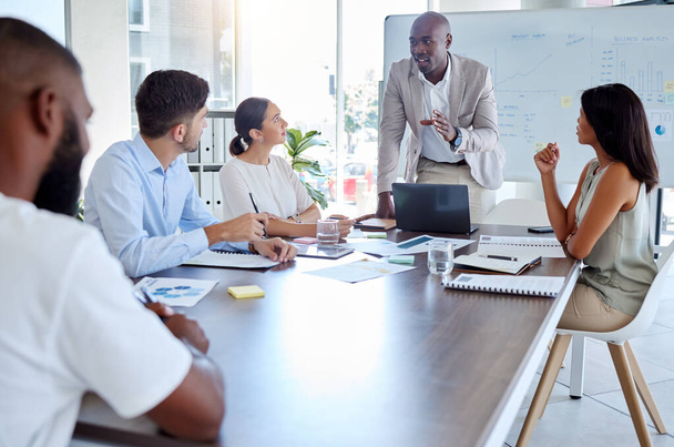 Black man, speaker and laptop presentation in business meeting, strategy planning and digital marketing global office boardroom. Talking manager, mentor and leadership technology in teamwork training. - 写真・画像