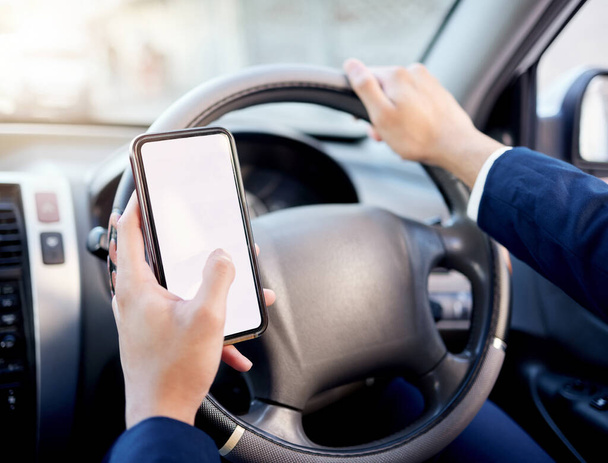 Rather keep your eyes on street than on your screen. Closeup shot of an unrecognisable businessman using a cellphone while driving a car - Photo, Image