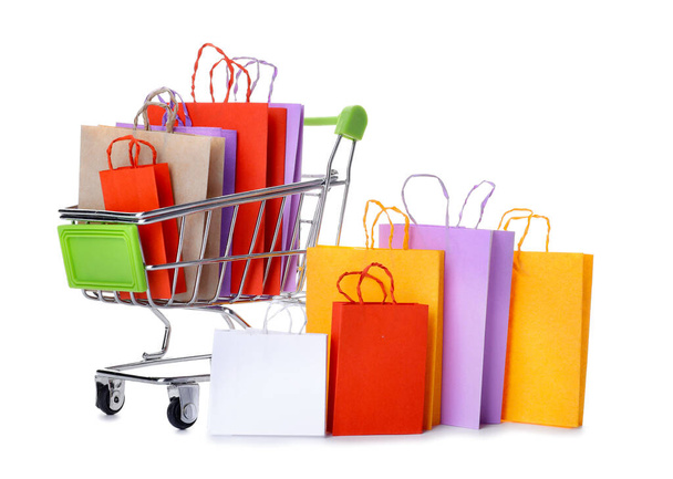 Shopping cart with different paper bags on white background - Foto, immagini