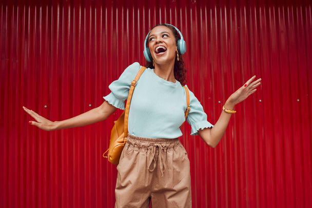 Happy woman streaming music, singing and hip hop dance on stage with headphones. Young musical performer, fun and energy in trendy fashion .....broadway.solo act.dancing.listen to music.hip hop rmb. - Photo, Image