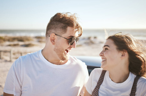 Travel, beach and holiday in summer with happy couple smile, love and laugh while on the ocean by the seaside. Happy french man and woman enjoy exotic honeymoon having fun at sea tropical vacation. - 写真・画像