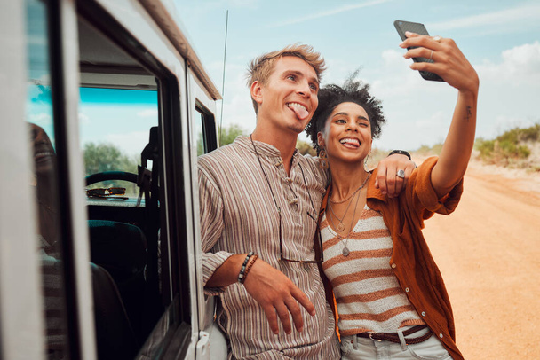 Road trip, travel and selfie couple with smartphone and van in desert for outdoor adventure with social media post update. Love, gen z and influencer people in cellphone portrait for nature journey. - Photo, Image