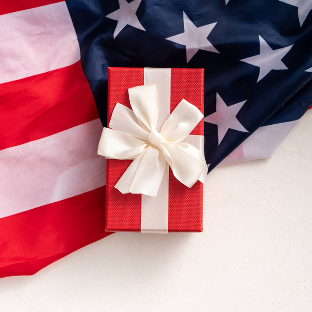 United States election design concept, top view of American Flag over white table background with gift box. - Foto, Bild