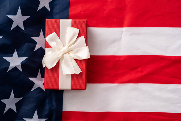 United States election design concept, top view of American Flag over white table background with gift box. - Photo, image