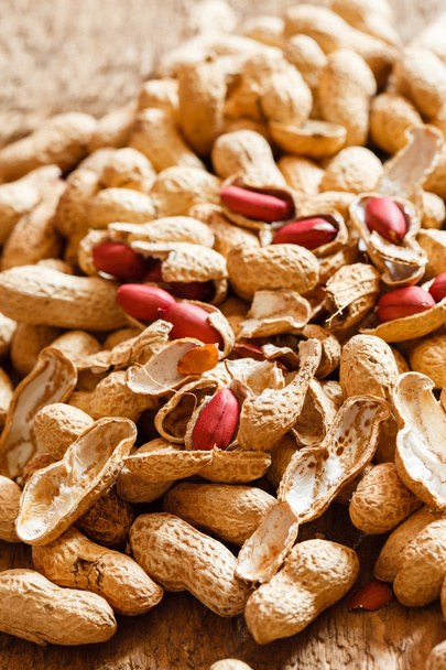 Peanuts on wood background - Фото, изображение