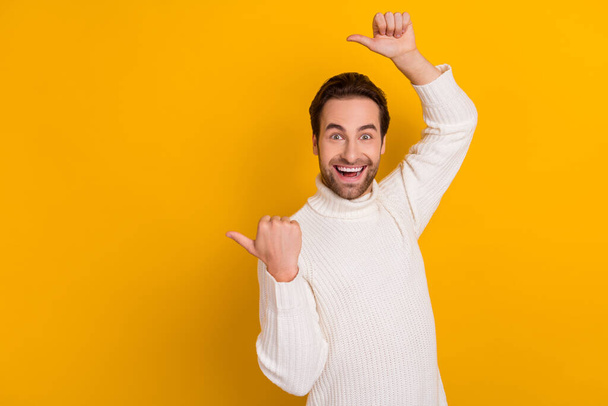 Photo of positive crazy guy party promotion concept blank space wear white sweater isolated yellow color background. - Fotoğraf, Görsel