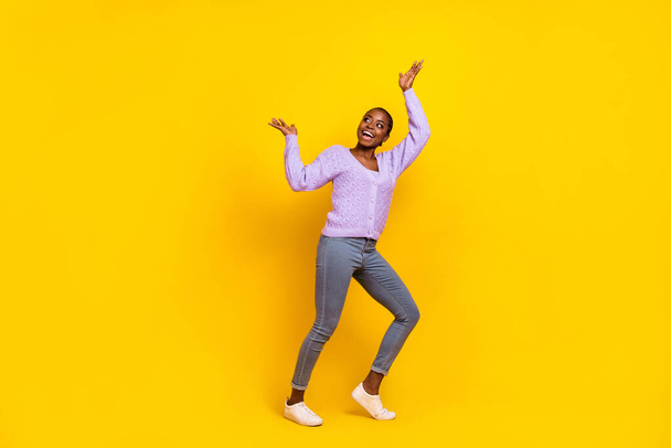 Full body portrait of positive excited lady look empty space arm palms catch isolated on yellow color background. - Φωτογραφία, εικόνα