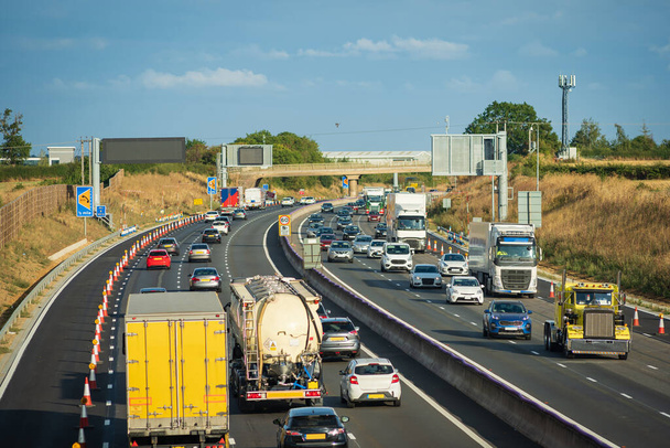 heavy traffic in blurry motion on UK motorway in England. - Photo, Image