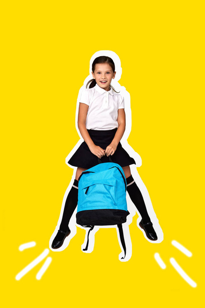 little pupil jumping with blue backpack isolated on yellow background. happy child is ready to learn. Back to school - Foto, Imagem