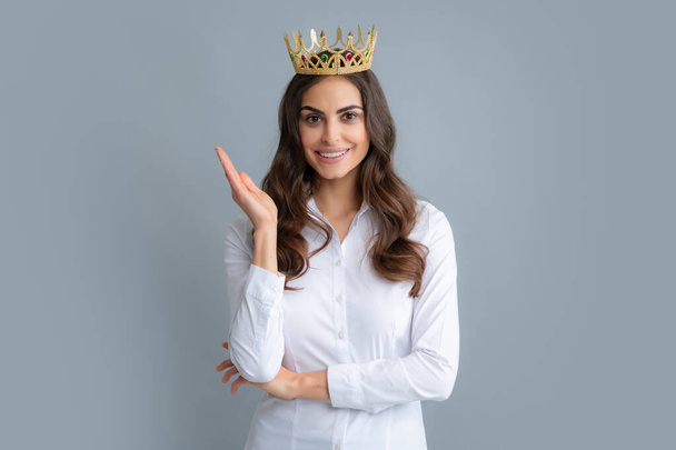 Young woman queen wear golden crown, isolated gray background - Foto, imagen