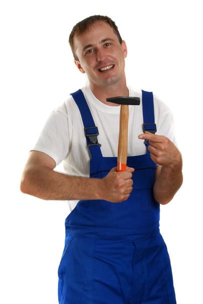 Craftsman with a white T-shirt holding a hammer - Fotoğraf, Görsel