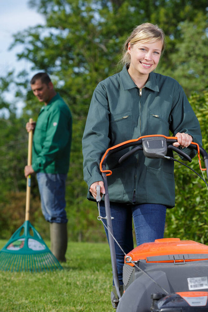 happy young woman with lawn mower - Фото, зображення