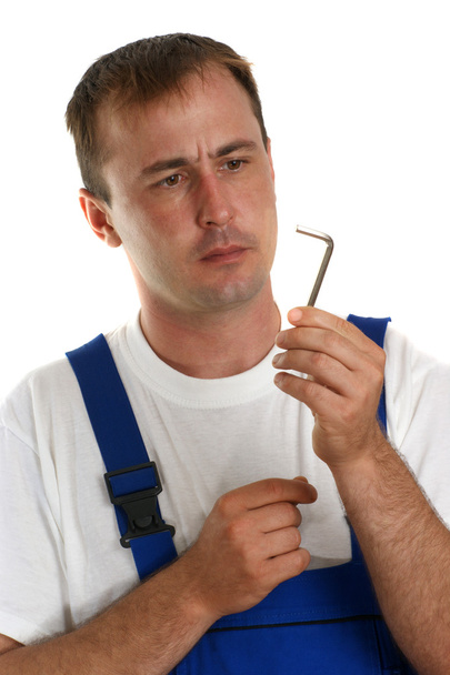 řemeslníci v modrých montérkách drží klíčem - Fotografie, Obrázek