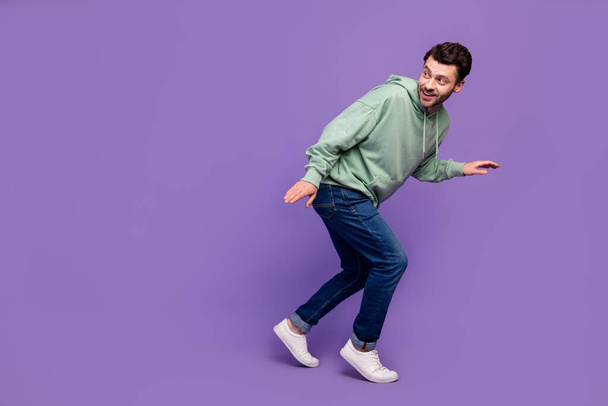 Full length side profile photo of nervous funny man look empty space walk silent robbery dont want wake up owners isolated on pastel violet color background. - Φωτογραφία, εικόνα