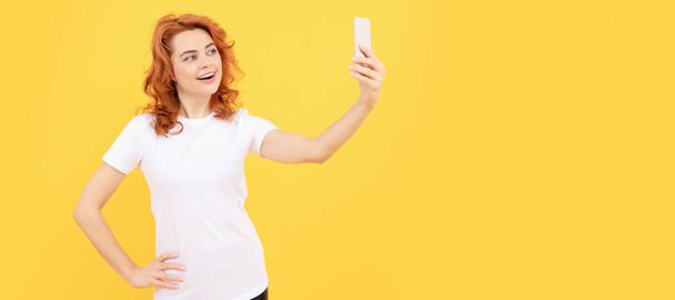 Woman isolated face portrait, banner with mock up copy space. Image of excited happy young woman isolated overyellow background make selfie by camera - Foto, Imagen