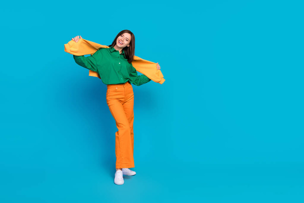 Full length photo of overjoyed lady wear sweatshirt shoulders nice outfit go city center empty space isolated on blue color background. - Foto, Imagen