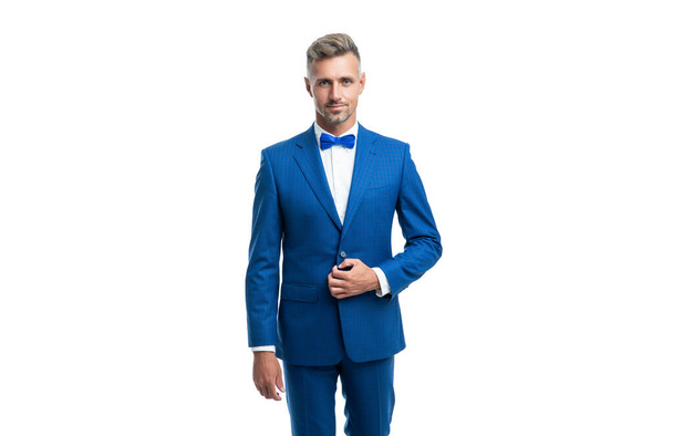 confident formal man in blue tuxedo bowtie isolated on white background. - Foto, Imagem