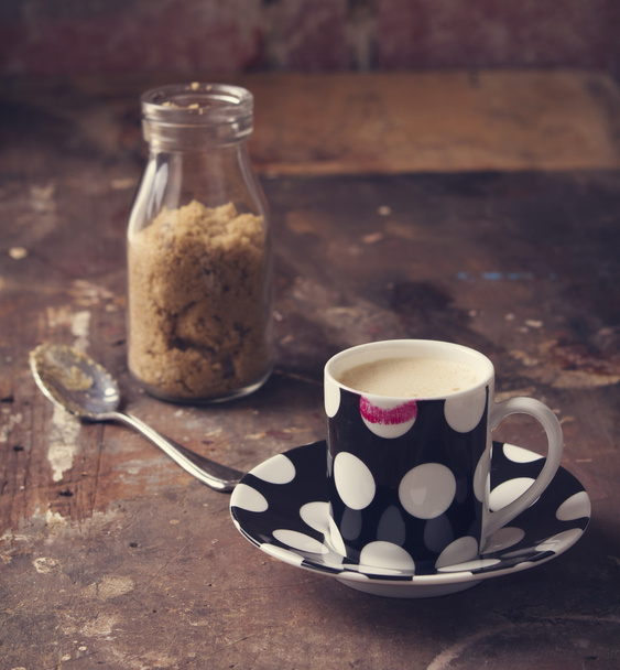 Lipstick on coffee cup in rustic cafe or studio setting - Photo, Image