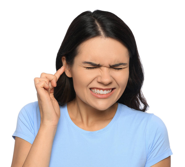 Young woman suffering from ear pain on white background - Photo, Image