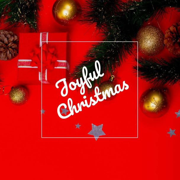 Composition of christmas greetings text over christmas decoration and red background. Christmas, festivity, tradition and celebration concept. - Photo, Image