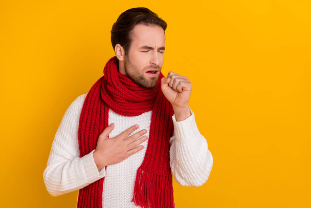 Photo of troubled guy suffer coughing touch sick lungs wear white pullover isolated yellow color background. - Foto, Bild