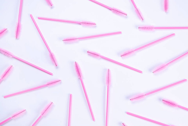 background with pink brushes for eyelashes or eyebrows on a white background, the concept of cosmetic care products, beauty salon or beauty and fashion industry.  - Fotó, kép