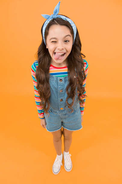 Beauty is whatever brings joy. Playful child grimace yellow background. Little girl in casual style. Beauty look of small fashion model. Beauty salon. Fashion and beauty. Children clothing. - Foto, immagini
