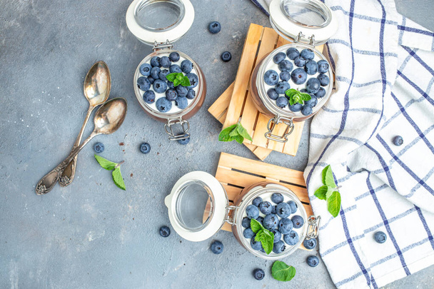 yogurt and blueberries. Healthy breakfast. Super food healthy eating vegetarian vegan food. banner, menu, recipe place for text, top view. - Foto, immagini