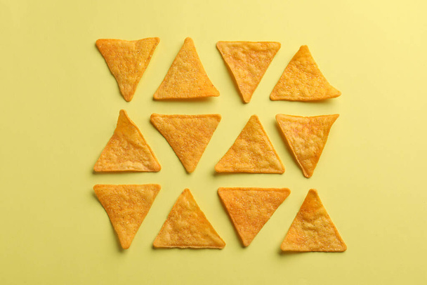 Flat lay composition of tortilla chips (nachos) on yellow background - Foto, Imagen