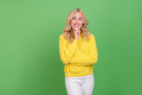 Photo of cute young blond lady look pomo wear yellow pullover isolated on green color background. - Foto, imagen