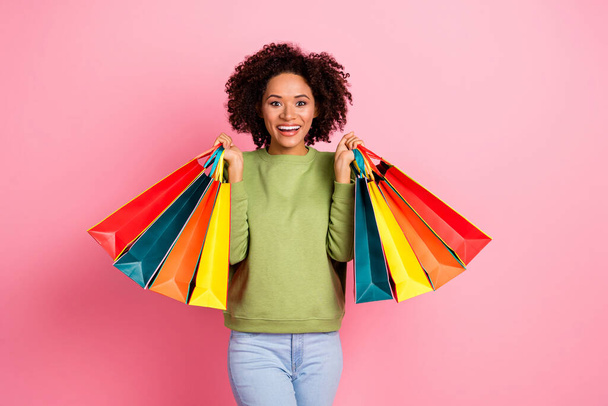 Photo of young excited lovely girl shopping store buy present holiday isolated over pink color background. - Foto, Imagem