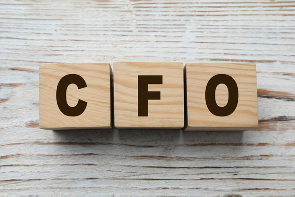 Abbreviation CFO of cubes on white wooden table, flat lay. Financial management - Foto, Bild