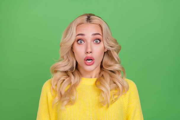 Photo of stressed millennial blond lady open mouth wear yellow sweater isolated on green color background. - Foto, Bild