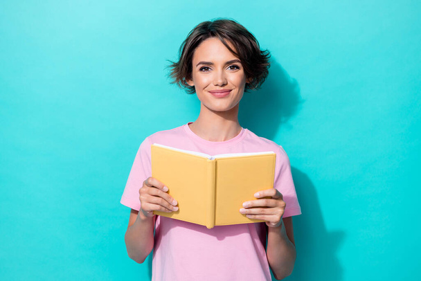 Portrait photo of young cute pretty woman wear pink t-shirt hold yellow book diary nerd isolated on cyan color background. - Φωτογραφία, εικόνα