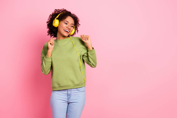 Photo of young excited girl have fun listen radio earphones look empty space hang-out isolated over pink color background. - Фото, зображення