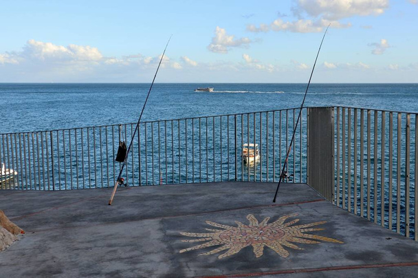 Praiano, Campania, Italia - 1 de octubre de 2022: Cañas de pescar a lo largo del camino costero en Marina di Praia - Foto, imagen